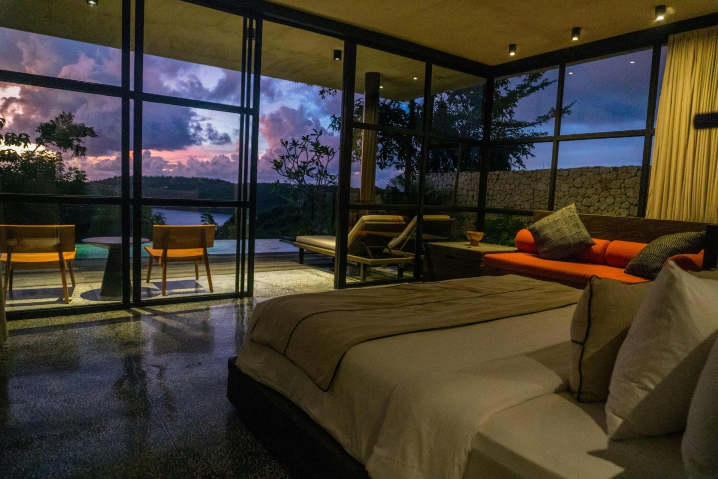 A bedroom with a large bed sitting next to a window
